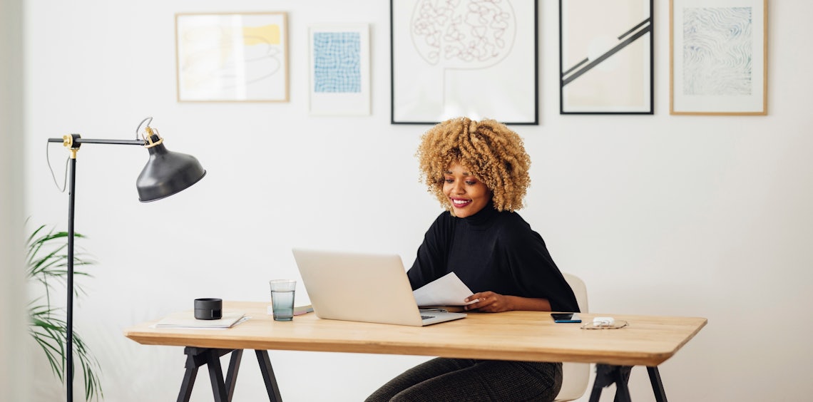 picture of a sales woman sitting at a modern desk entering data into the company's CRM
