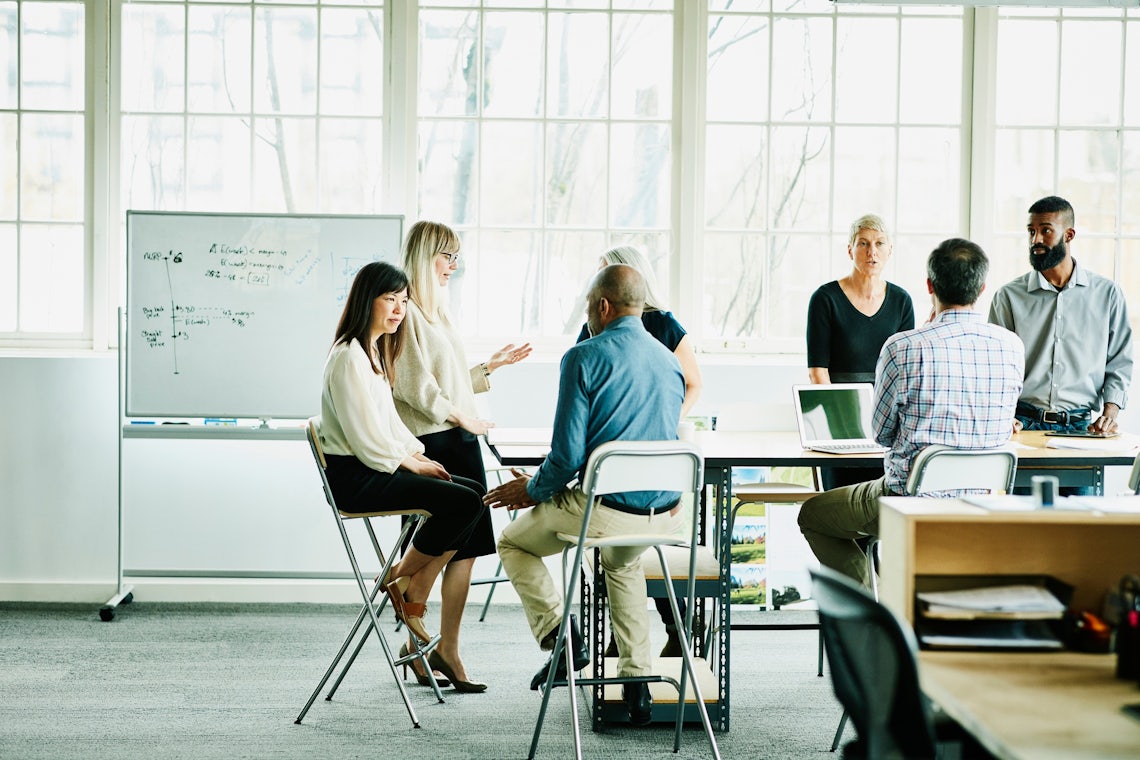 a diverse team of sellers in an open, airy office are lead by a confident manager who is using new skills learned from Richardson training to address their unique needs and drive collective success.