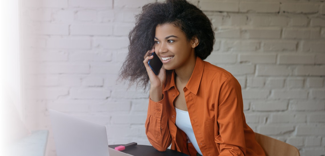 Sales Development Representative (SDR) on a sales call looking happy