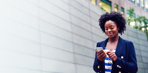 young stylish african american sales person completing her prospecting activities on her phone because she has the ability to prospect with agility after completing richardson's prospecting training program