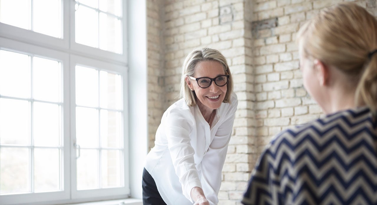 female sales manager leading an insightful and productive sales coaching conversation with her sales rep