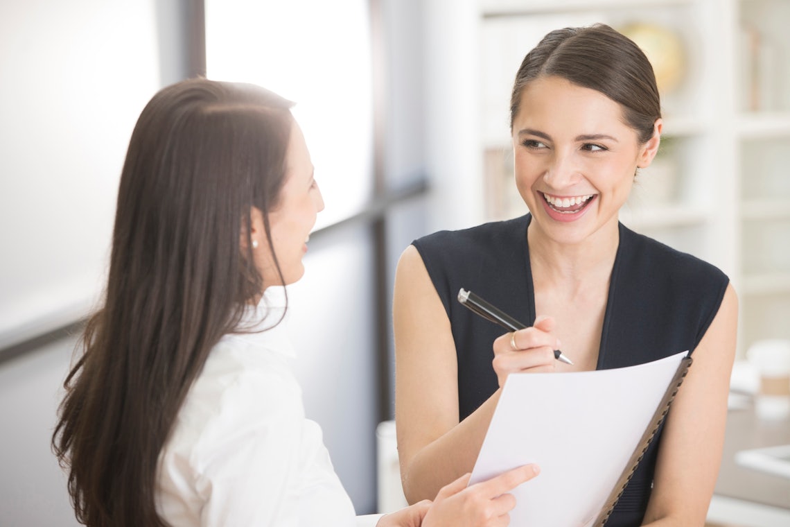 a sales manager and her report having an engaging conversation and achieving results because their team has a culture of accountability
