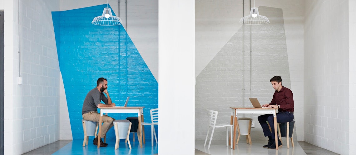 two salesmen sitting in small rooms on independent sales learning journeys