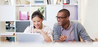 young revenue operations and sales operations professionals sitting together at a modern desk working together to optimize their organization's sales efforts