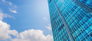 picture of a city skyline from the perspective of a person looking up from the street
