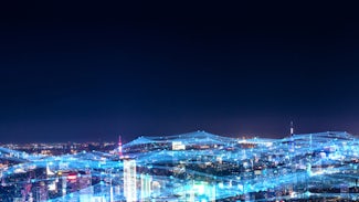 city skyline with lights connecting buildings to symbolize mitels work in telecommunications